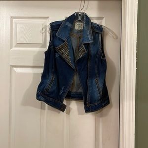 Blue jean vest with gold grommets and zippers.